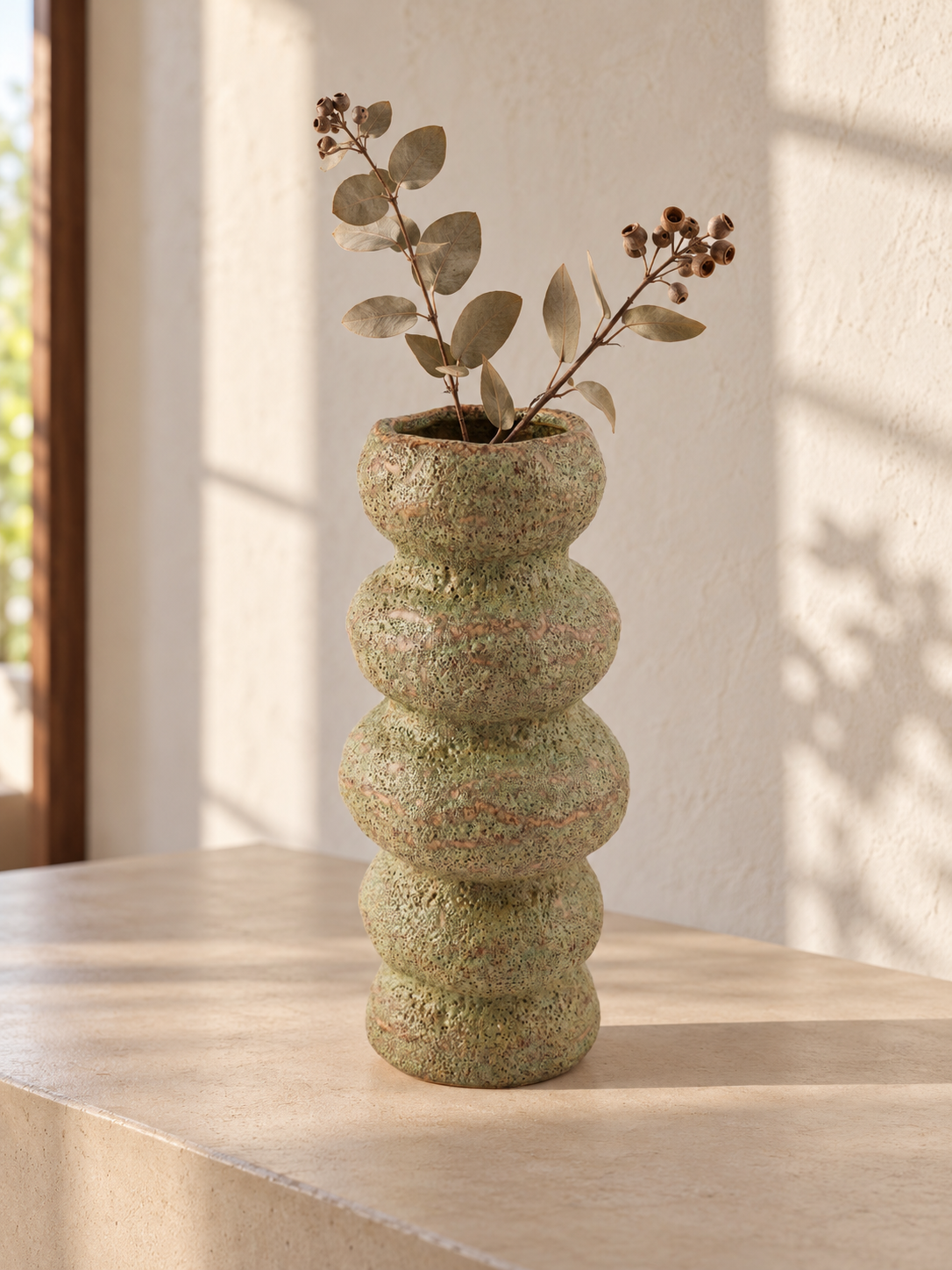 T&CO modern ceramic stacked ring bubble flower vase in textured speckled sage green 23cm displayed with dried eucalyptus branches