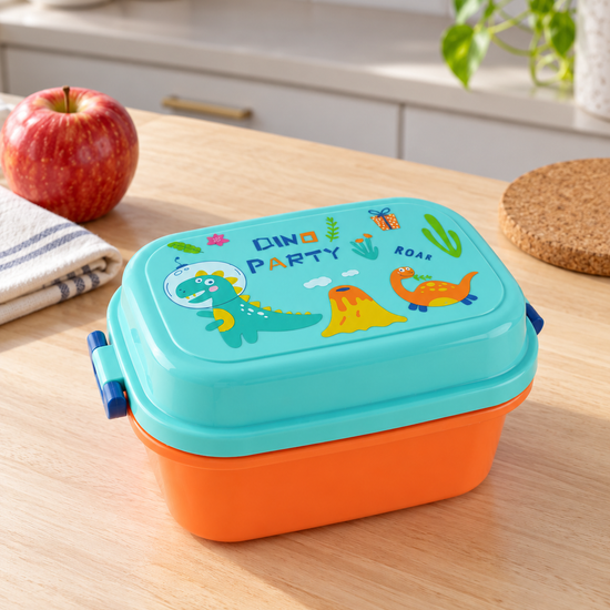 T&CO kids Dino Party bento lunch box with bright orange base and aqua blue lid featuring cartoon dinosaur illustrations and blue side latches