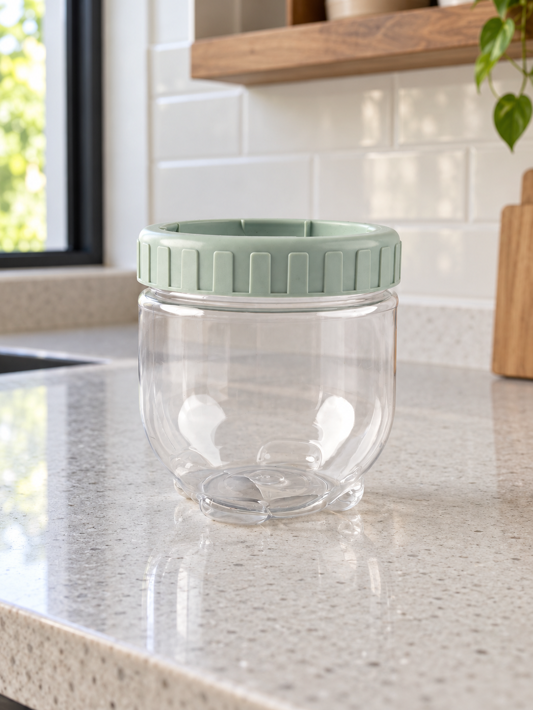T&CO clear glass kitchen storage jar with ribbed slate blue twist-lock lid and molded feet base 9cm height by 9cm diameter