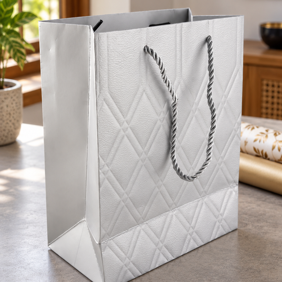 Small silver quilted diamond metallic gift bag with twisted silver rope handles