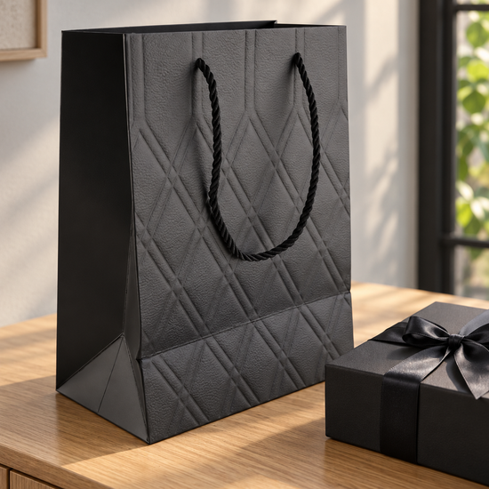 Small black quilted diamond gift bag with matching twisted black rope handles