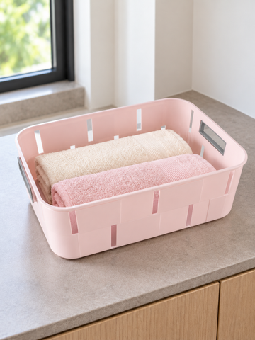 Pastel pink plastic storage tub basket with cutout side handles for home organization