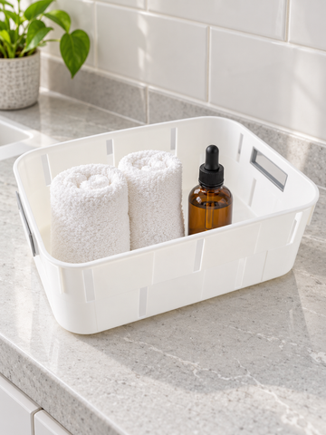 Classic white plastic storage tub basket with cutout side handles for shelf organization