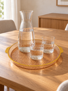Medium round plastic serving tray with raised rim angled view