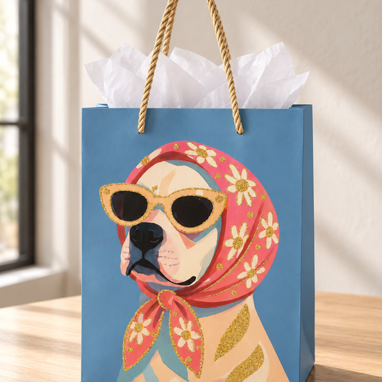 Retro Rosie small sky blue paper gift bag featuring a chic dog wearing a pink floral headscarf and sunglasses with twisted gold cord handles