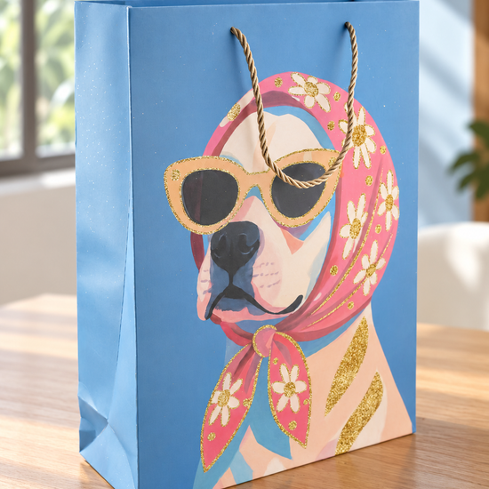 Retro Rosie large sky blue paper gift bag featuring dog in floral headscarf and sunglasses with thick twisted gold rope handles