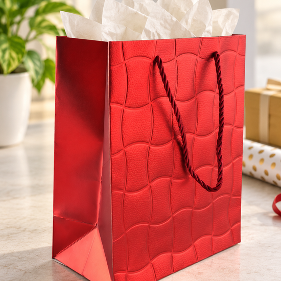 Embossed Ripple Wave small paper gift bag in textured metallic crimson red with undulating wave grid pattern and twisted red rope handles