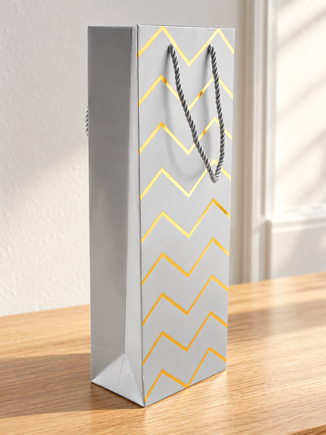 Silver metallic chevron zigzag foil single wine bottle gift bag measuring 13 by 8.5 by 36 cm with rope handles