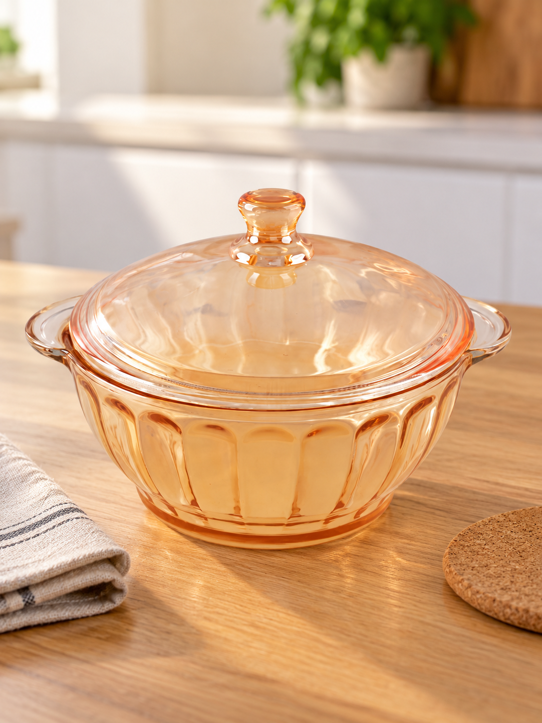 Fluted amber glass round casserole serving dish with matching domed knobbed lid and integrated side handles
