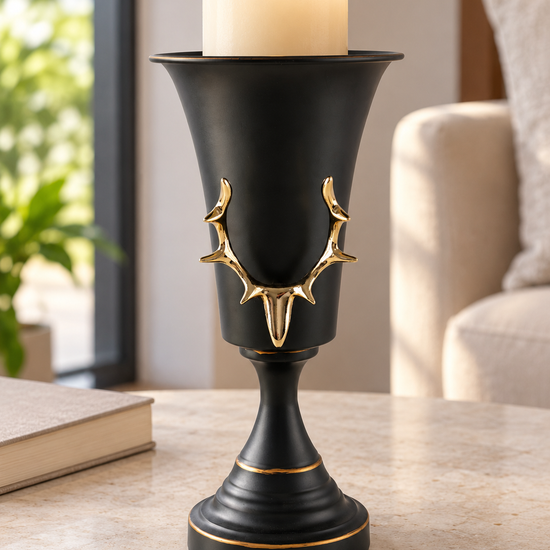 Matte black urn chalice pedestal pillar candle holder featuring an embossed gold stag antler crest and gilded rim