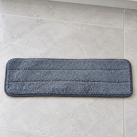 Grey rectangular microfiber replacement mop cleaning pad measuring 40 by 12 cm on ceramic tile floor