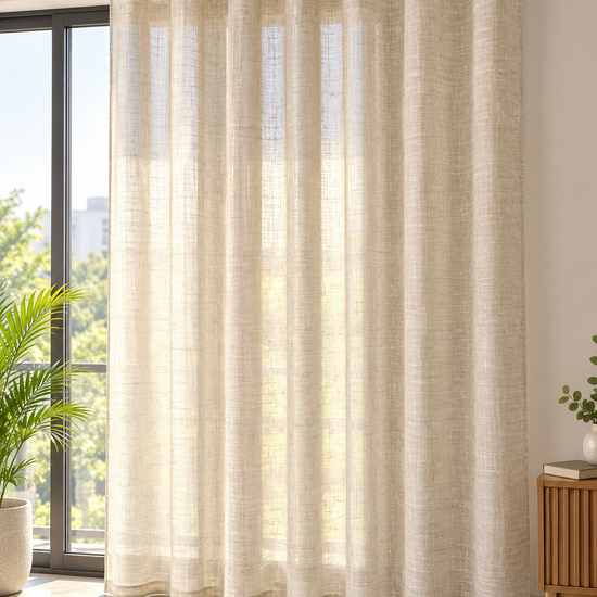 Warm sand beige textured slub linen look semi-sheer eyelet curtain drape panel hanging over balcony sliding door
