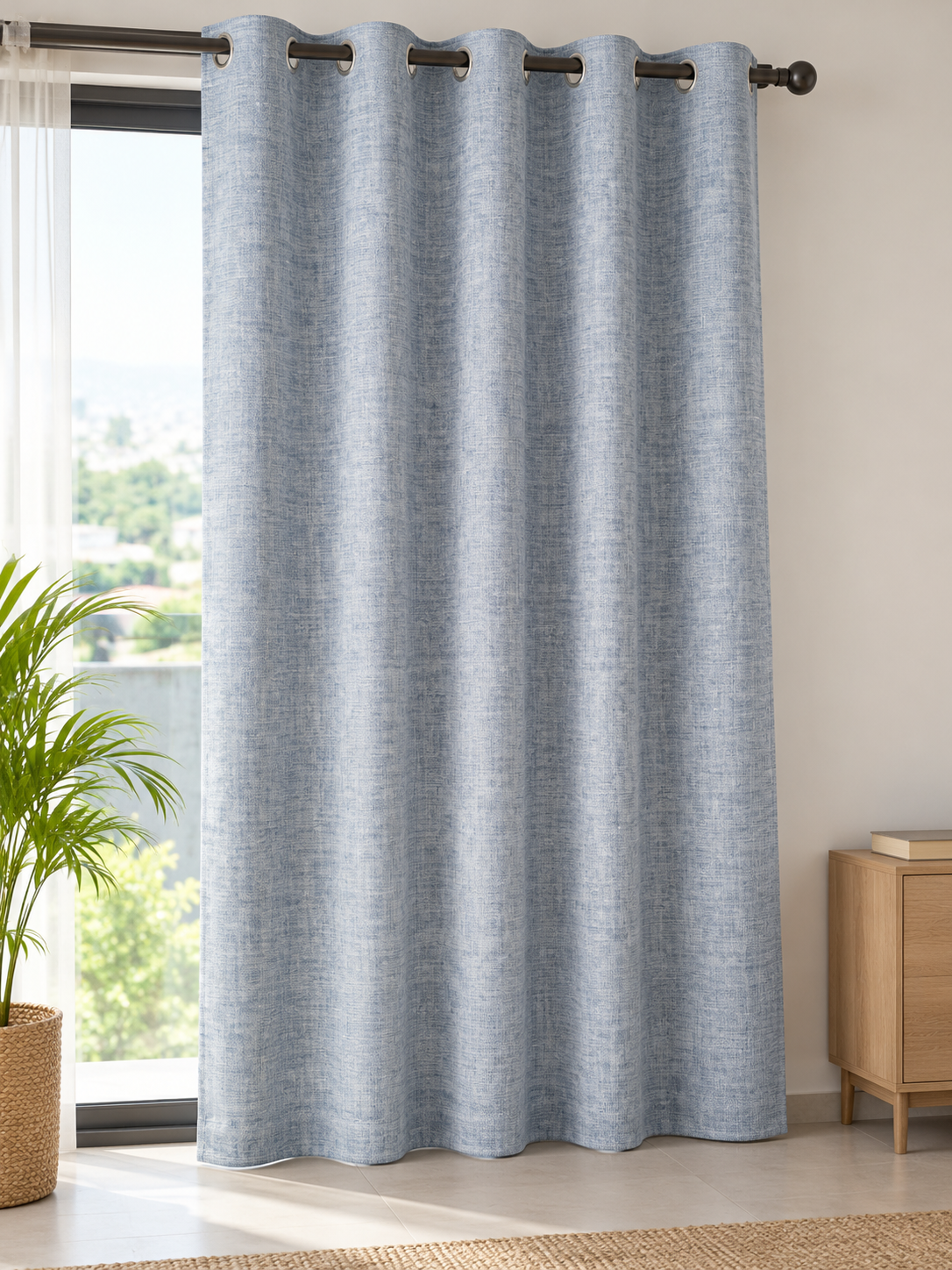 Denim blue chambray slub linen look eyelet window curtain panel hung neatly on curtain rod