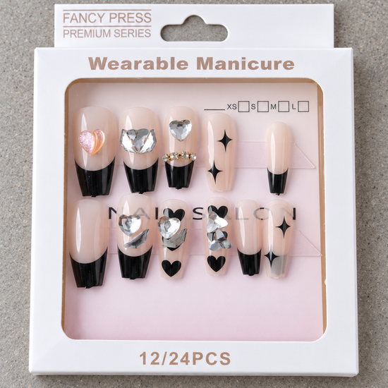 Fancy Press glossy black French tip ballerina coffin press-on nails with black hearts, starbursts, and heart gems
