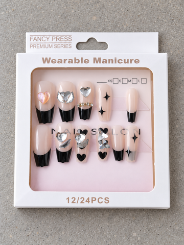 Fancy Press glossy black French tip ballerina coffin press-on nails with black hearts, starbursts, and heart gems