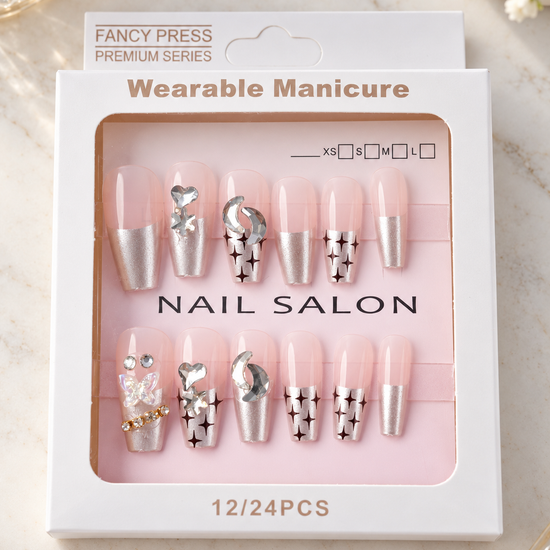 Fancy Press metallic chrome silver French tip coffin press-on nails with sparkle starbursts, crescent moons, and 3D butterfly