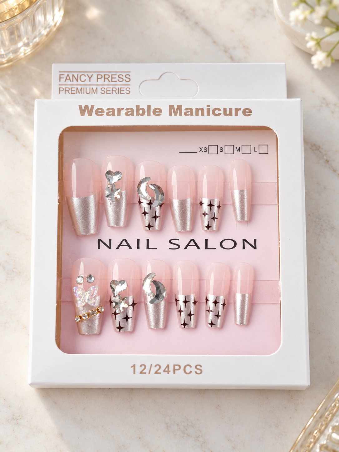 Fancy Press metallic chrome silver French tip coffin press-on nails with sparkle starbursts, crescent moons, and 3D butterfly