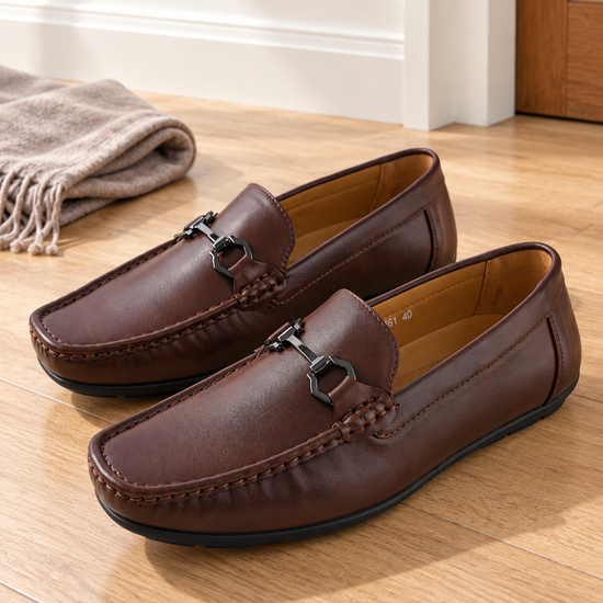 Men's rich brown faux leather horsebit driving loafers with gold-toned metal buckle hardware and textured driving outsole