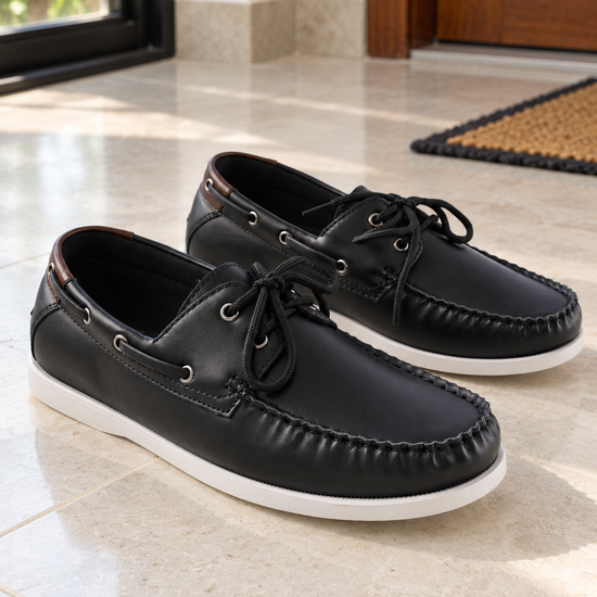 Men's black faux leather lace-up boat shoes with contrasting rich brown collar trim, 360-degree lacing, silver eyelets, and white rubber sole