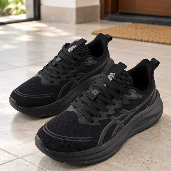 Men's all-black lightweight breathable knit mesh athletic running sneakers with thick shock-absorbing foam midsole, lace-up closure, and heel pull tab