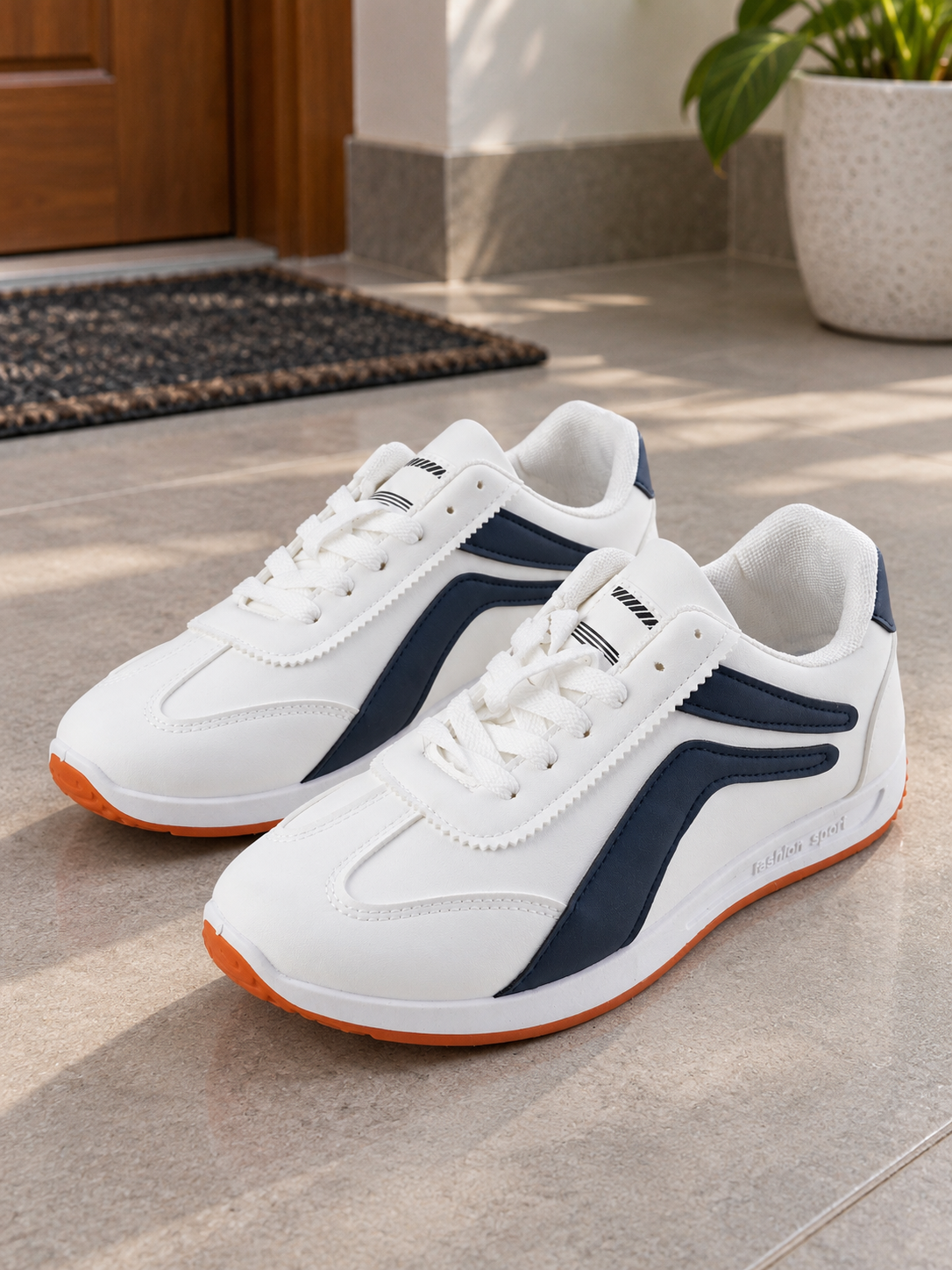 Men's clean white and navy blue low-top fashion sport casual sneakers with navy side stripes, white laces, and amber gum rubber outsole
