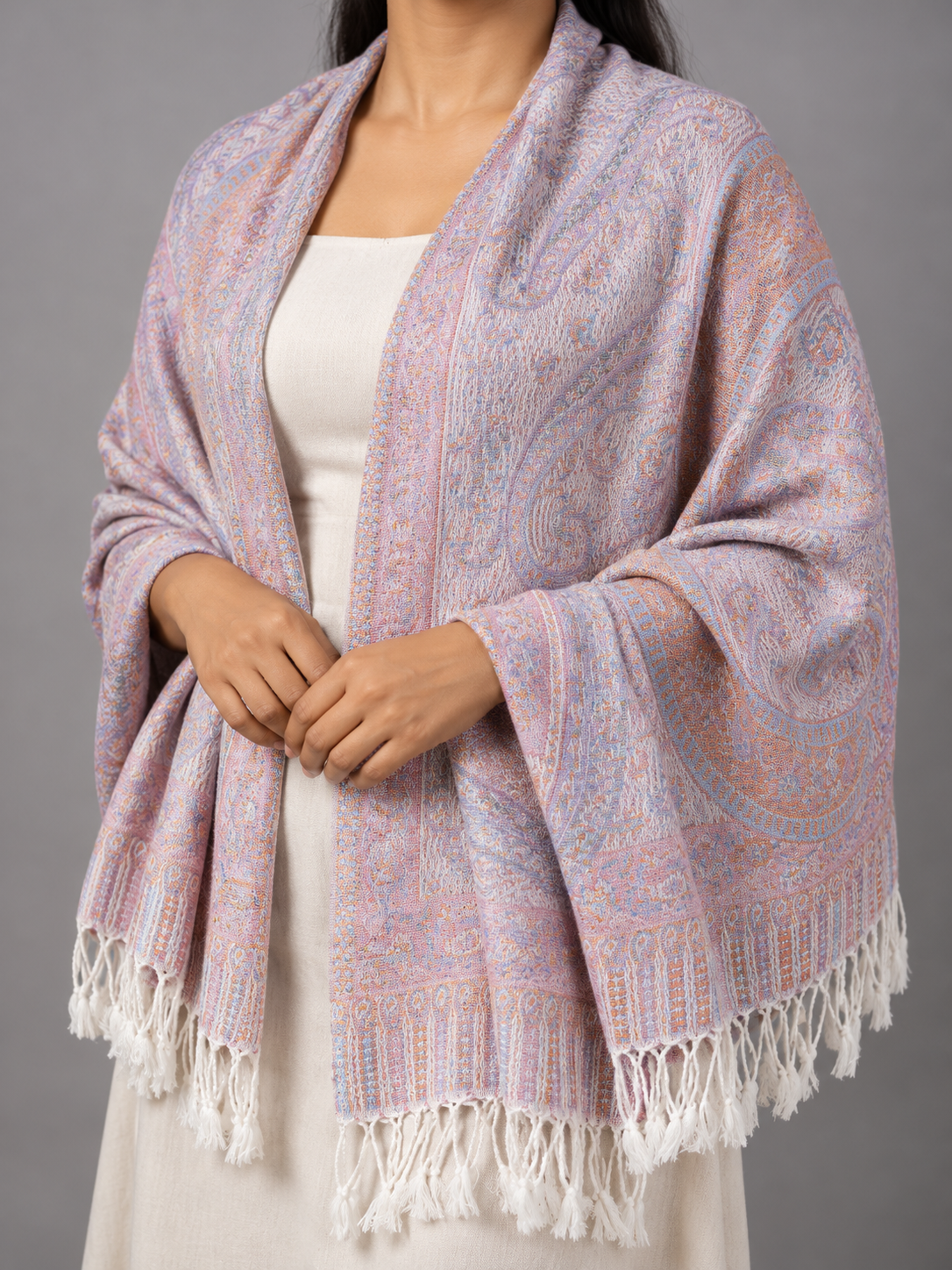 Women's pastel multi-tone jacquard pashmina shawl blending soft lilac lavender, blush pink, and sky blue with floral paisley motifs and white twisted fringe hem