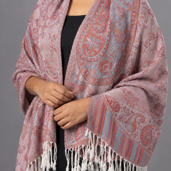 Women's dusty rose pink and slate teal blue jacquard woven pashmina wrap featuring paisley floral medallions, striped border, and white twisted fringe hem