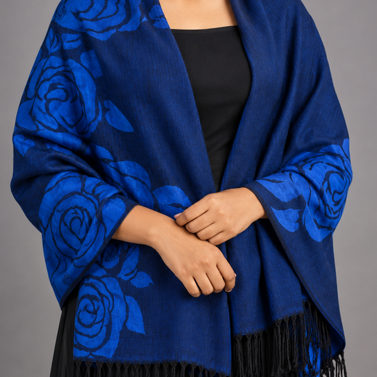 Women's royal sapphire blue and black reversible jacquard woven pashmina shawl featuring oversized stylized floral rose bouquets and knotted black tassel fringe