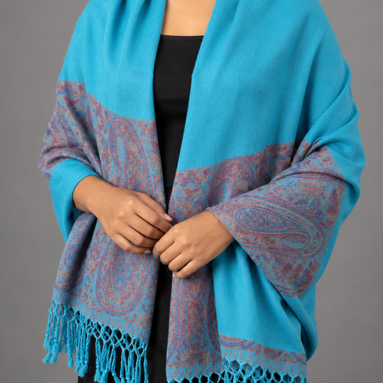 Women's vibrant cerulean turquoise blue pashmina shawl featuring smooth woven body, rich wine purple and maroon paisley tapestry border, and turquoise tassels