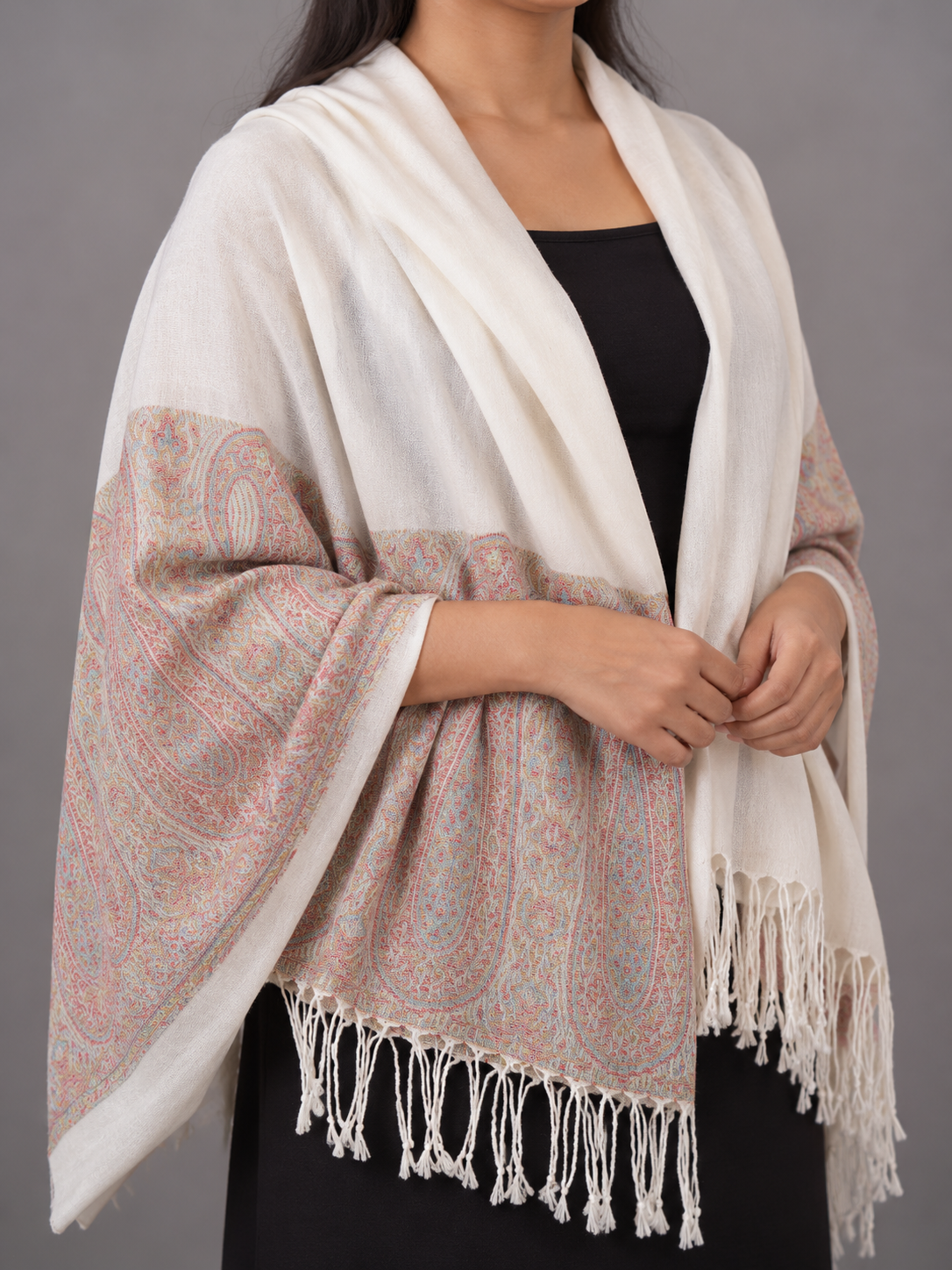 Women's ivory cream cashmere-feel pashmina wrap featuring soft pastel coral and powder blue floral paisley border with delicate white twisted fringe hem
