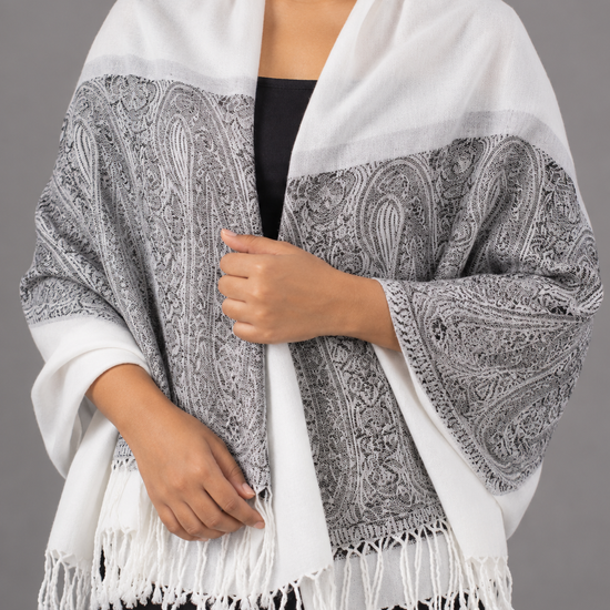 Women's white and charcoal grey jacquard pashmina shawl featuring crisp white body, intricate black and slate paisley boteh border, and white fringe tassels