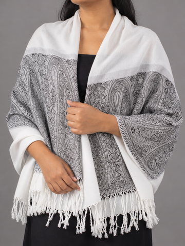 Women's white and charcoal grey jacquard pashmina shawl featuring crisp white body, intricate black and slate paisley boteh border, and white fringe tassels