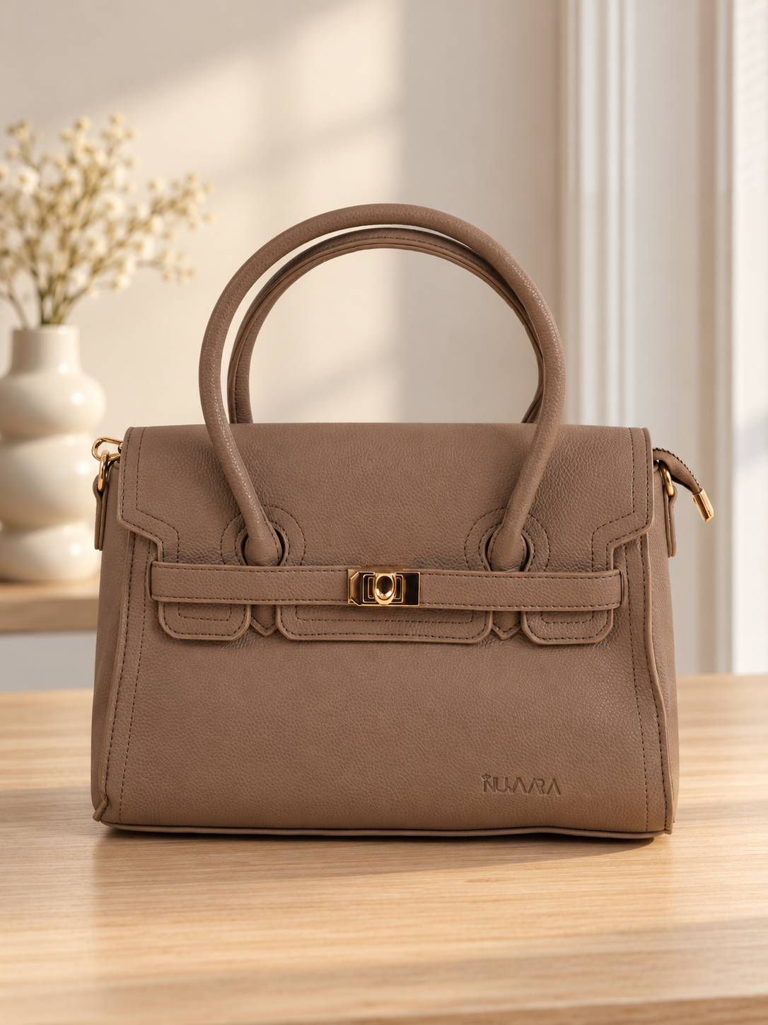 Nuvaara women's structured taupe grained vegan leather top-handle satchel handbag featuring front flap closure with gold-tone twist clasp and contoured dual handles