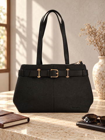 Nuvaara women's belted black grained vegan leather shoulder tote bag featuring front belt detail with polished gold buckle and tall shoulder handles