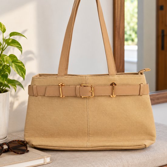 Nuvaara women's belted warm beige textured canvas and vegan leather shoulder tote bag featuring front belt detail with polished gold buckle and tall shoulder handles