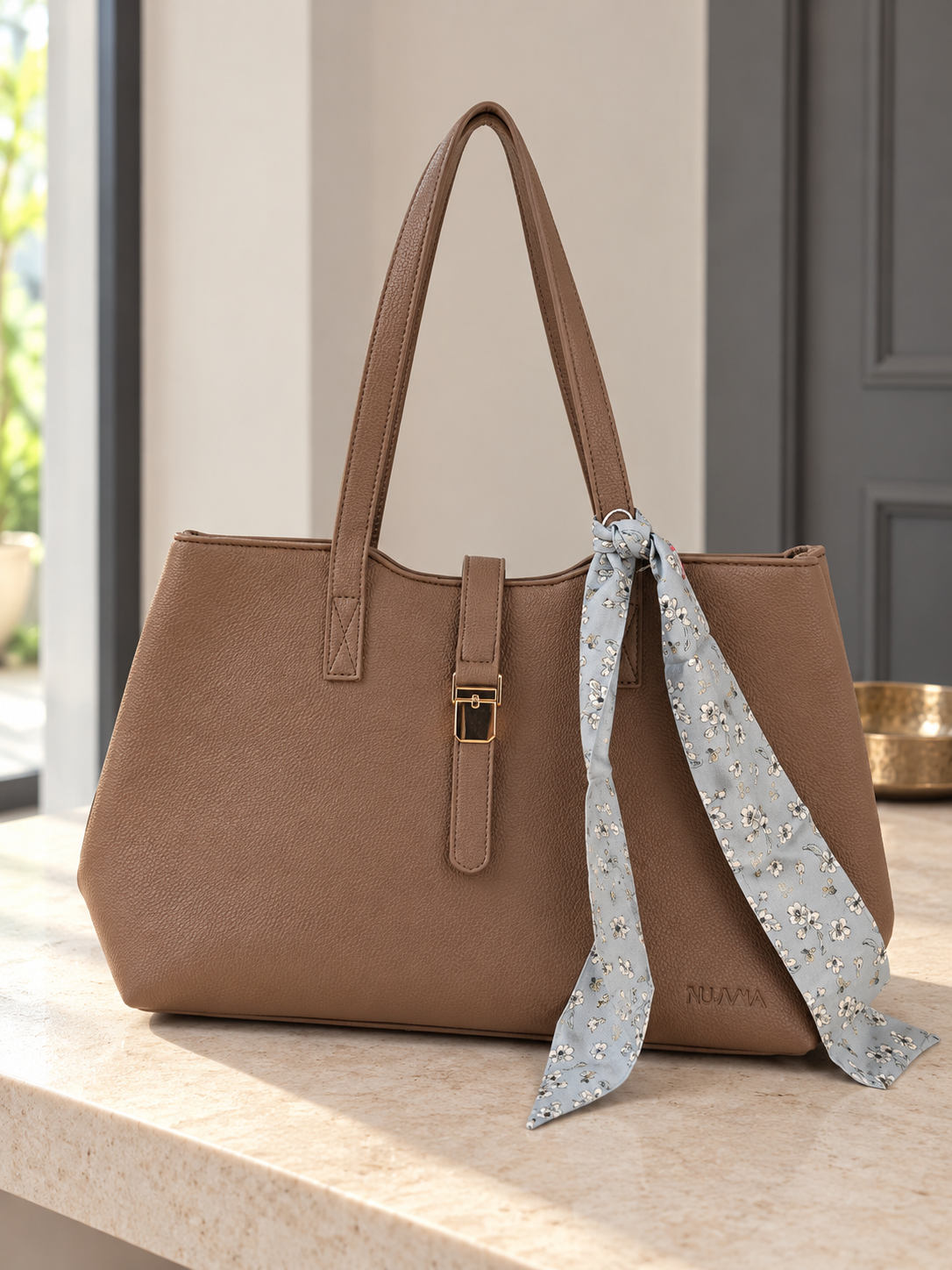 Nuvaara women's warm brown grained vegan leather shoulder tote bag featuring soft floral printed silk twilly scarf accent and gold center clasp