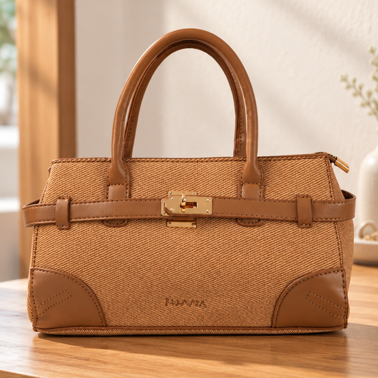 Nuvaara women's East-West structured warm tan twill satchel handbag with smooth vegan leather trim, front belt strap, and gold turn-lock plate