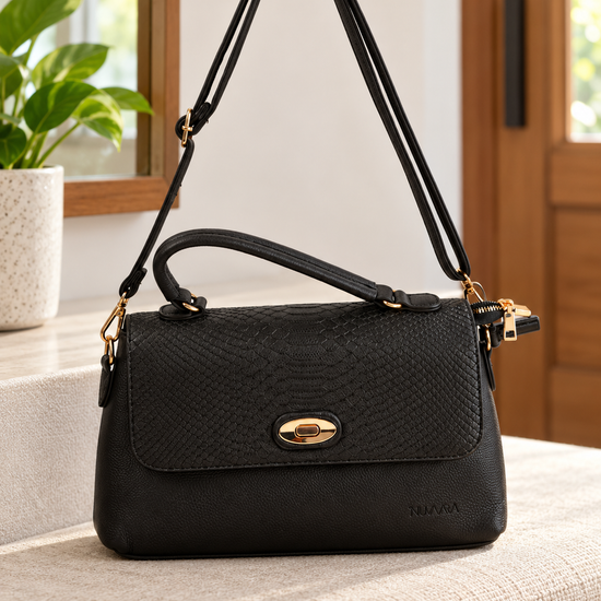Nuvaara women's structured black shoulder bag featuring snake-embossed front flap, gold oval turn-lock clasp, arched top handle, and crossbody strap