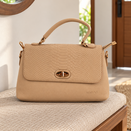 Nuvaara women's structured soft beige shoulder bag featuring snake-embossed front flap, gold oval turn-lock clasp, arched top handle, and crossbody strap