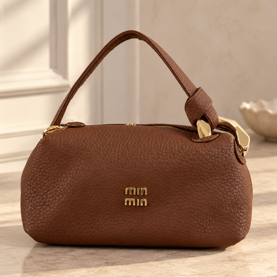 Nuvaara women's rich brown pebbled vegan leather shoulder handbag featuring an asymmetric knotted handle accented with chunky polished gold-tone metal chain link