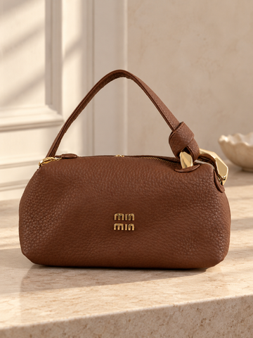 Nuvaara women's rich brown pebbled vegan leather shoulder handbag featuring an asymmetric knotted handle accented with chunky polished gold-tone metal chain link