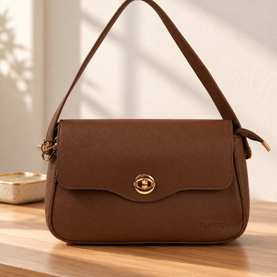 Nuvaara women's cognac brown pebbled vegan leather shoulder bag featuring a contoured scalloped front flap and ribbed circular gold turn-lock clasp
