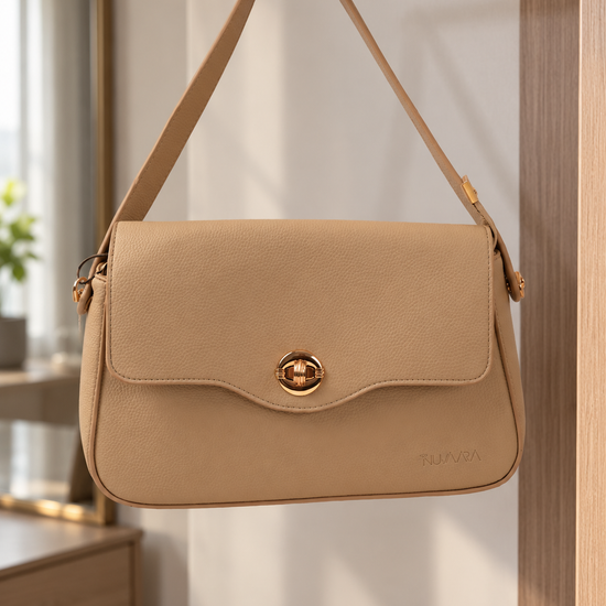 Nuvaara women's almond beige pebbled vegan leather shoulder bag featuring a contoured scalloped front flap and ribbed circular gold turn-lock clasp
