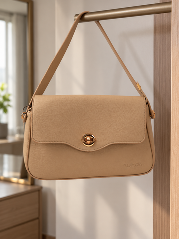 Nuvaara women's almond beige pebbled vegan leather shoulder bag featuring a contoured scalloped front flap and ribbed circular gold turn-lock clasp