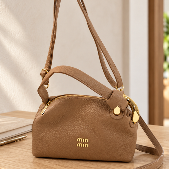 Nuvaara women's warm camel pebbled vegan leather shoulder handbag featuring an asymmetric knotted handle accented with chunky polished gold-tone metal chain link