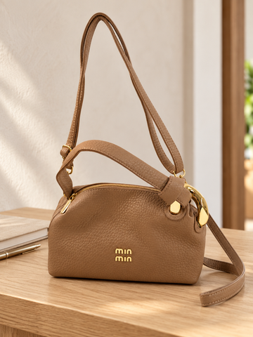 Nuvaara women's warm camel pebbled vegan leather shoulder handbag featuring an asymmetric knotted handle accented with chunky polished gold-tone metal chain link
