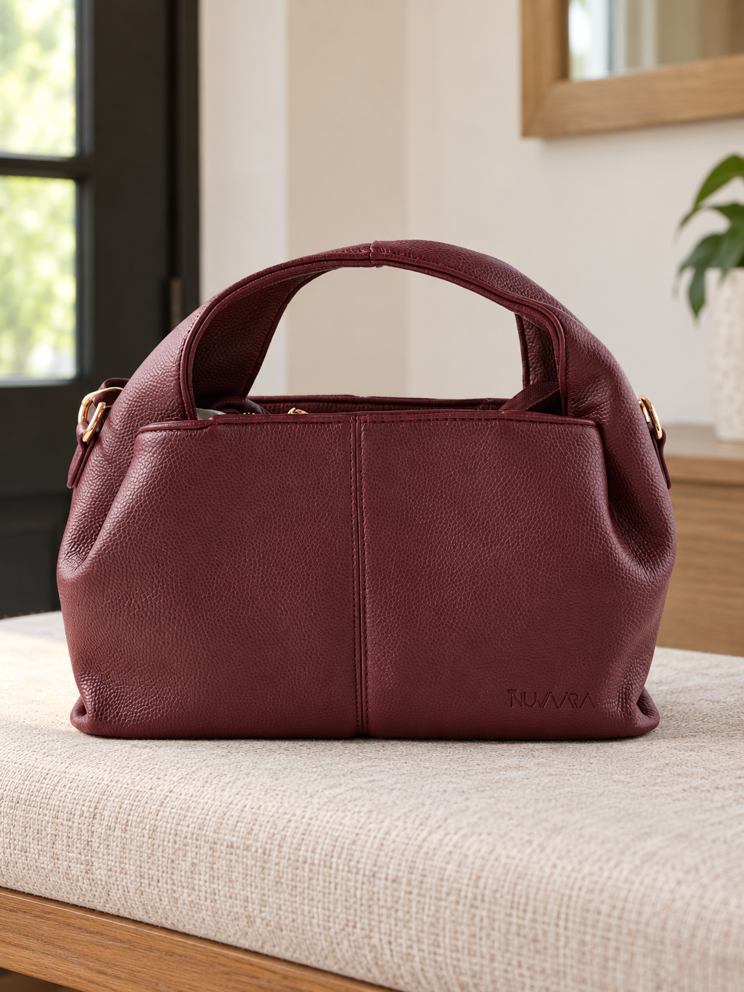 Nuvaara women's wine burgundy pebbled vegan leather slouchy curved dome satchel handbag with center vertical seam, dual arched handles, and debossed logo