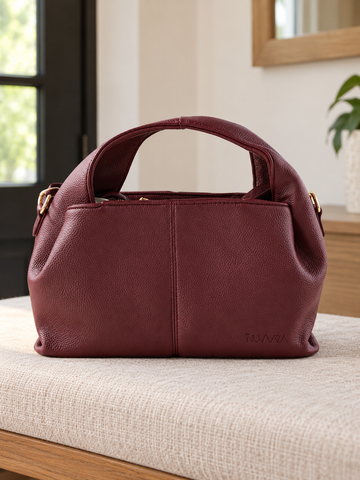 Nuvaara women's wine burgundy pebbled vegan leather slouchy curved dome satchel handbag with center vertical seam, dual arched handles, and debossed logo
