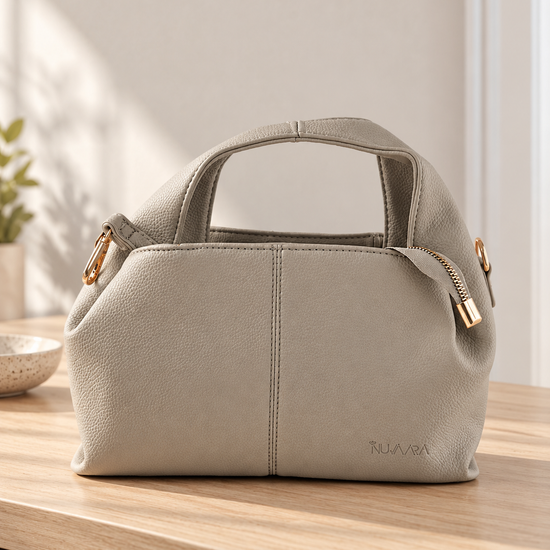 Nuvaara women's slate grey pebbled vegan leather slouchy curved dome satchel handbag with center vertical seam, dual arched handles, and debossed logo