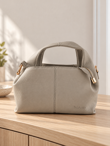 Nuvaara women's slate grey pebbled vegan leather slouchy curved dome satchel handbag with center vertical seam, dual arched handles, and debossed logo